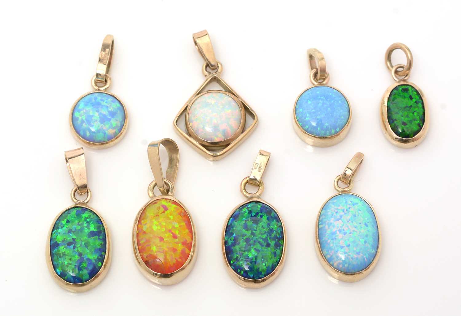 Lot 384 - Eight synthetic opal pendants
