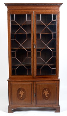 Lot 1074 - A 19th Century fiddle back mahogany and satinwood banded bookcase