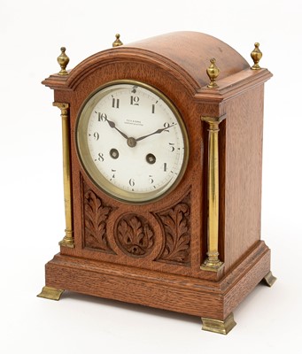 Lot 996 - Samuel Marti: a late 19th C carved oak mantel clock.