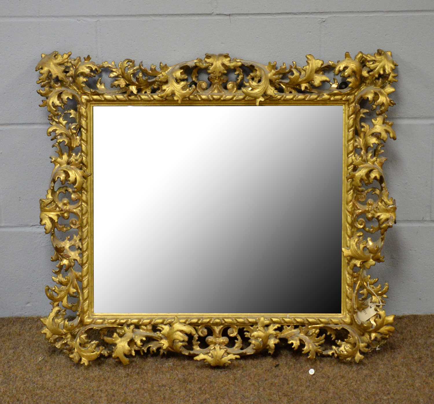 Lot 93 - An ornate gilt gesso wall mirror