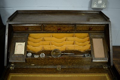 Lot 76 - A mid-20th Century carved oak writing bureau.