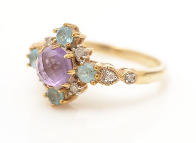 Lot 49 - An amethyst, topaz and diamond ring