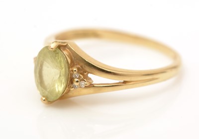 Lot 67 - A yellow gemstone and diamond ring
