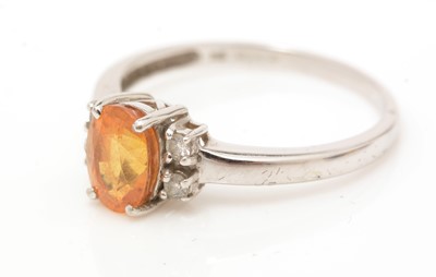 Lot 76 - An orange sapphire and diamond ring