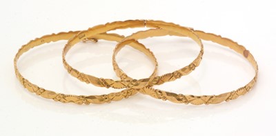 Lot 136 - A set of three Chinese gold bangles