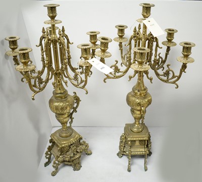 Lot 495 - Pair of Victorian brass six-branch candelabra.