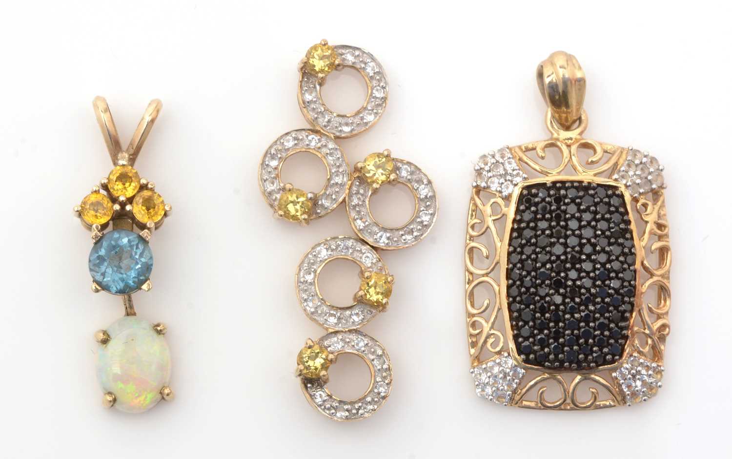 Lot 249 - Three gemstone pendants.