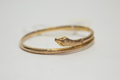 Lot 132 - A gold snake pattern bangle and three others.