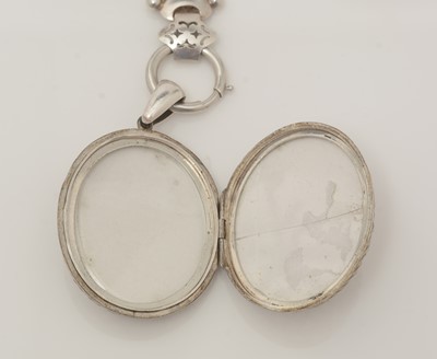 Lot 155 - A Victorian white metal locket pendant and chain