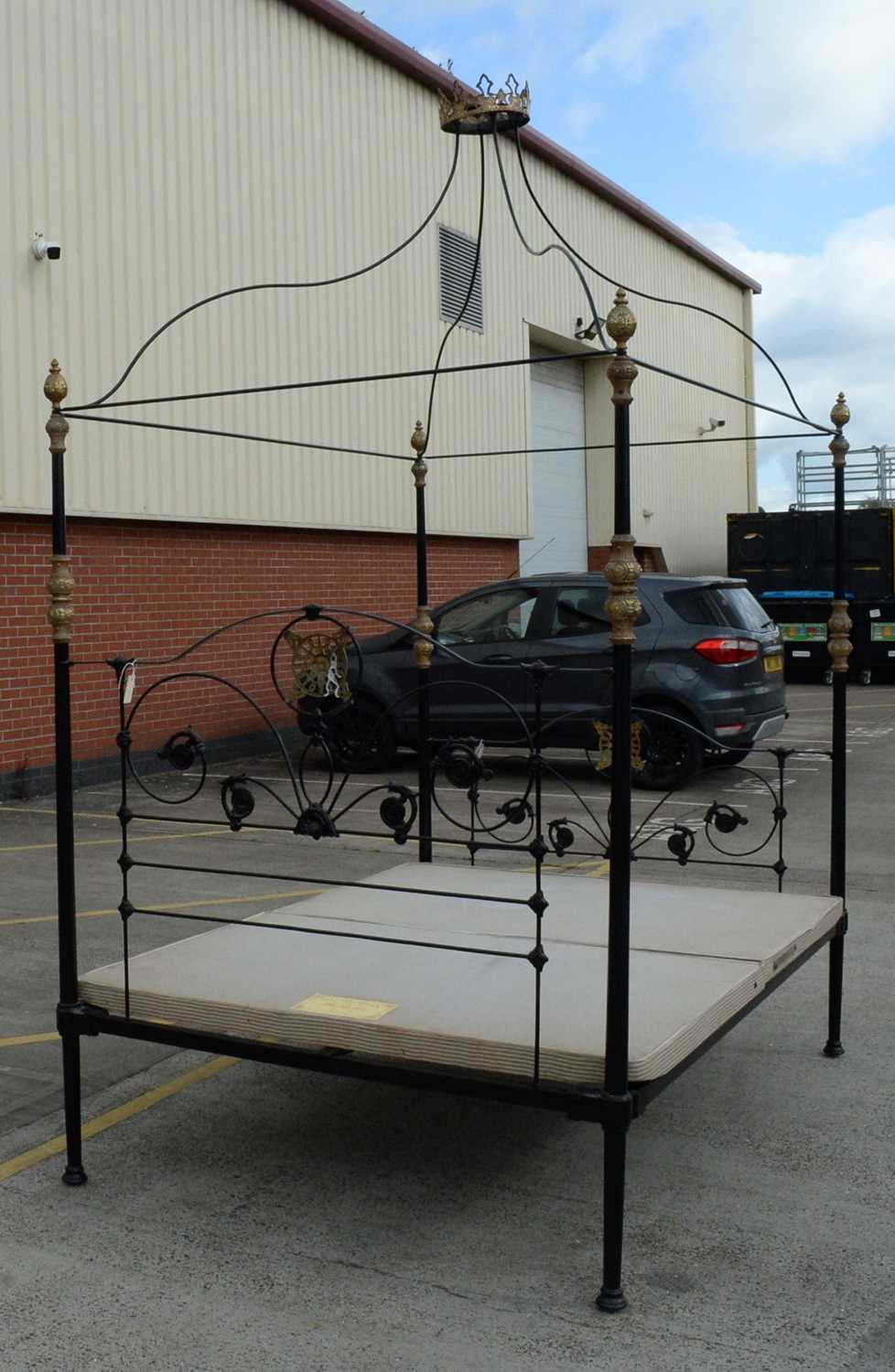 Lot 18 An ornate wrought metal four poster bed