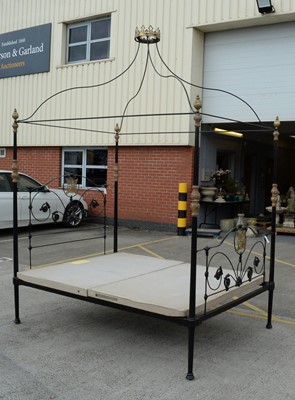 Lot 68 - An ornate wrought metal four poster bed