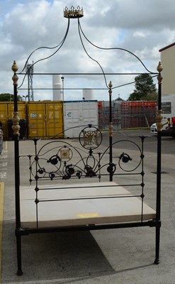Lot 68 - An ornate wrought metal four poster bed