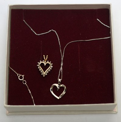 Lot 219 - Two diamond set heart shaped pendants
