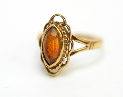 Lot 203 - An amber and diamond dress ring, and four others