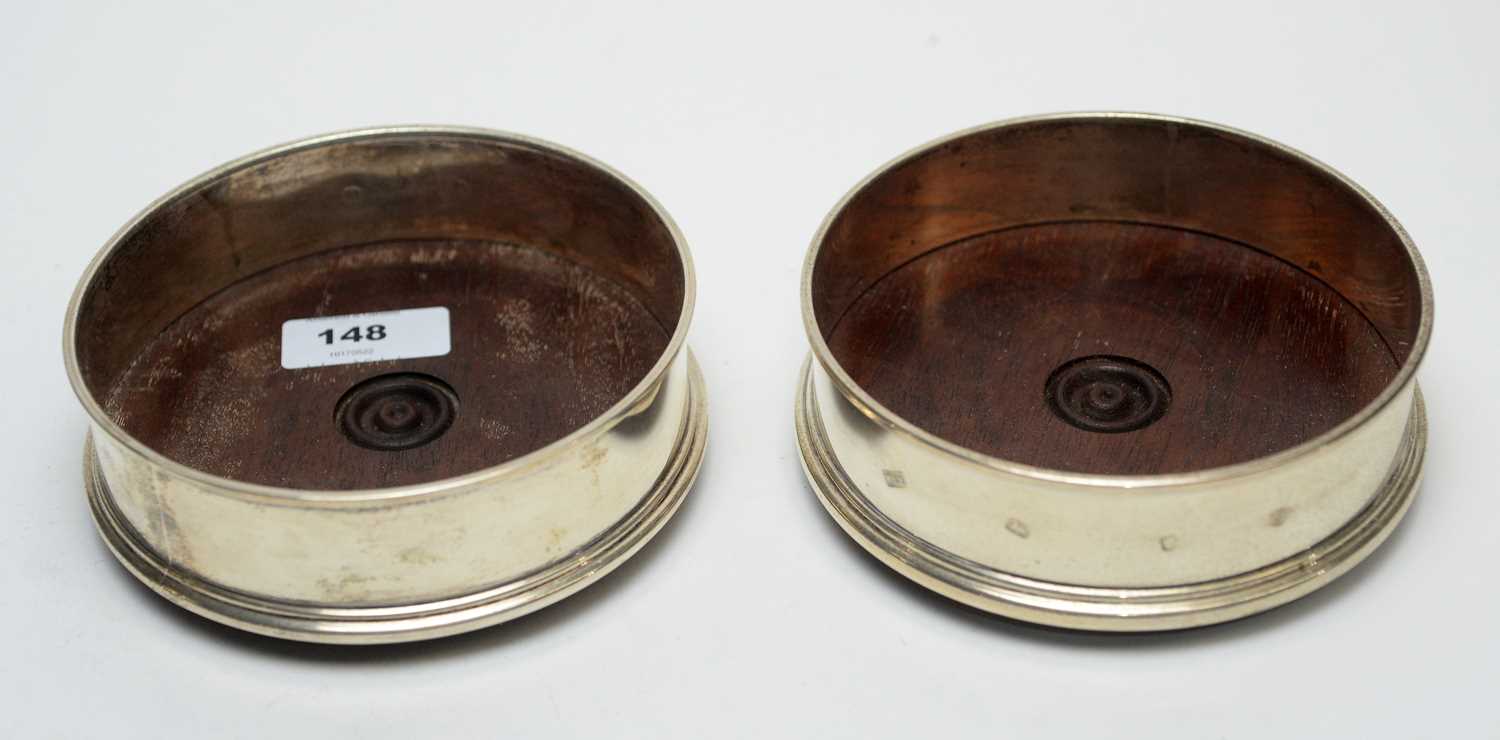 Lot 148 - A pair of silver bottle coasters