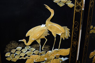 Lot 64 - A Japanese black lacquered and gilt painted folding dressing screen