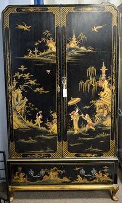 Lot 79 - A mid 20th Century black lacquered wardrobe decorated chinoiserie designs.