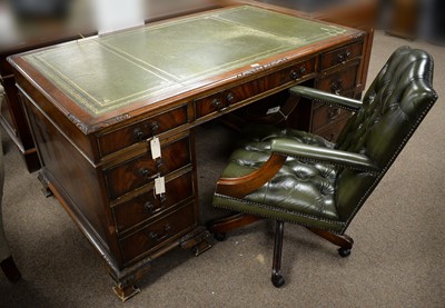 Lot 89 - A Victorian style carved mahogany writing desk, and a matched desk chair.