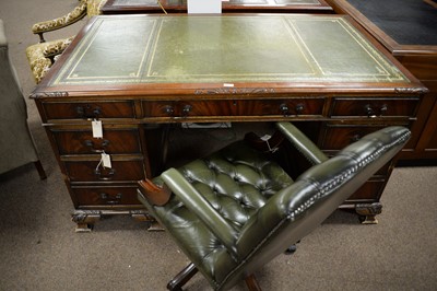 Lot 89 - A Victorian style carved mahogany writing desk, and a matched desk chair.