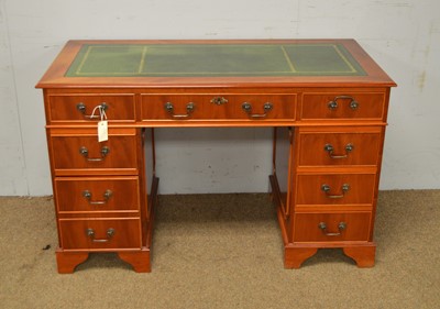 Lot 23 - A reproduction yew wood veneered twin pedestal writing desk.