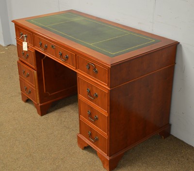 Lot 23 - A reproduction yew wood veneered twin pedestal writing desk.