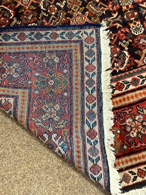 Lot 91 - An Eastern bordered carpet.