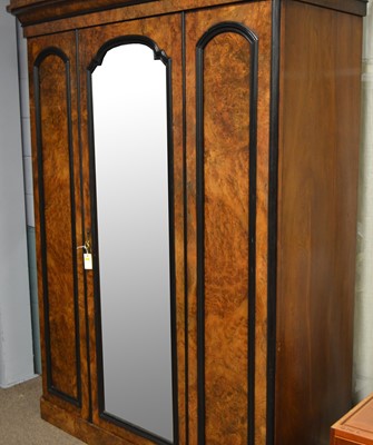 Lot 89 - A Victorian burr walnut and ebonised three door wardrobe.