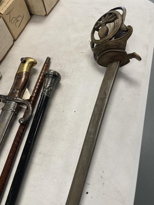 Lot 496 - A walking stick, a walking cane, sword and bayonet