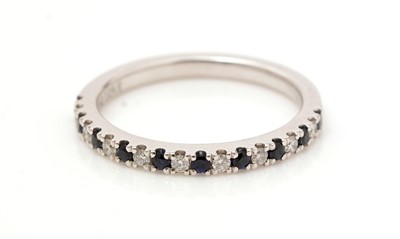 Lot 472 - A sapphire and diamond half-hoop eternity ring