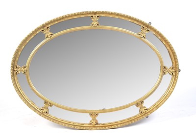 Lot 1020 - A decorative oval gilt gesso wall mirror.