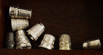 Lot 305 - A selection of silver and other thimbles.