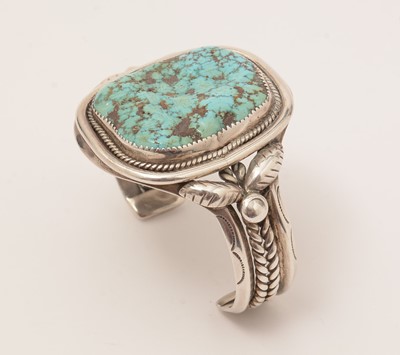 Lot 880 - Mary S. Lew, Navajo, Native American: a silver and rough turquoise bangle