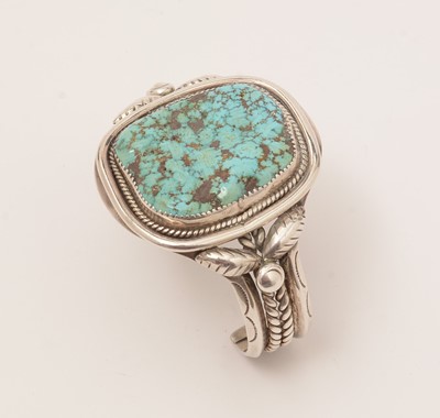 Lot 880 - Mary S. Lew, Navajo, Native American: a silver and rough turquoise bangle