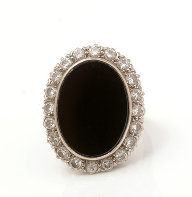 Lot 486 - An onyx and diamond cluster ring