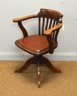 Lot 19 - An early 20th Century stained beech swivel office armchair