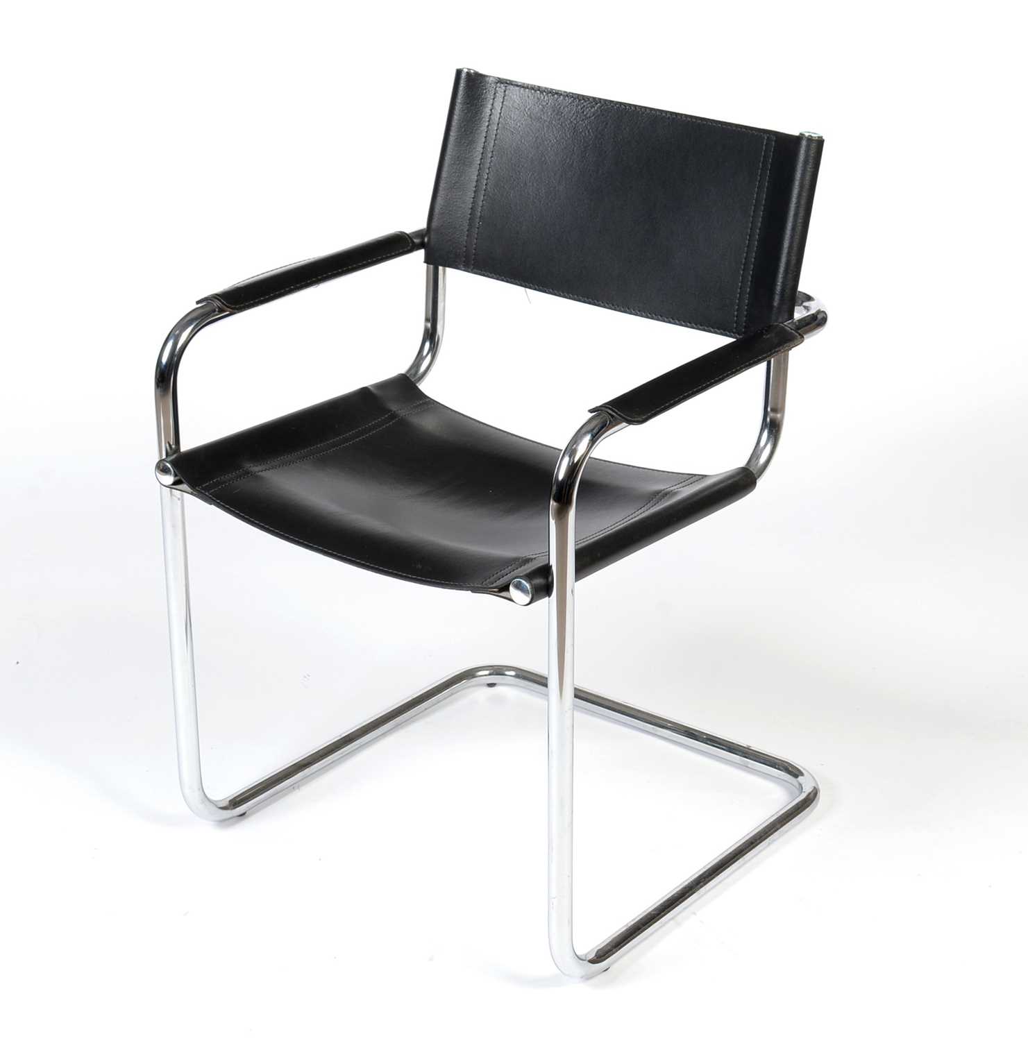 Lot 376 - A mid-Century style shaped chromed metal and black leather armchair, modern.