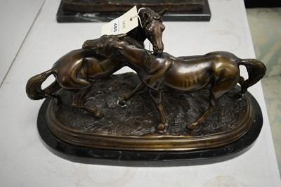 Lot 485 - A bronzed figure group of two horses.