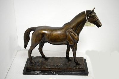 Lot 486 - A bronzed figure group of a horse.