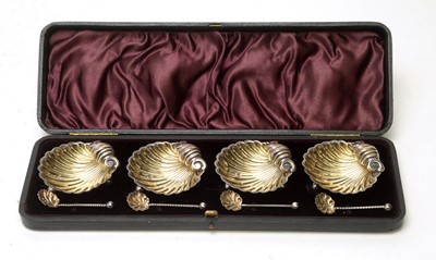 Lot 570 - A set of four silver table salts with matching spoons