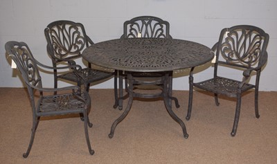 Lot 65 - A cast metal garden table and chairs.