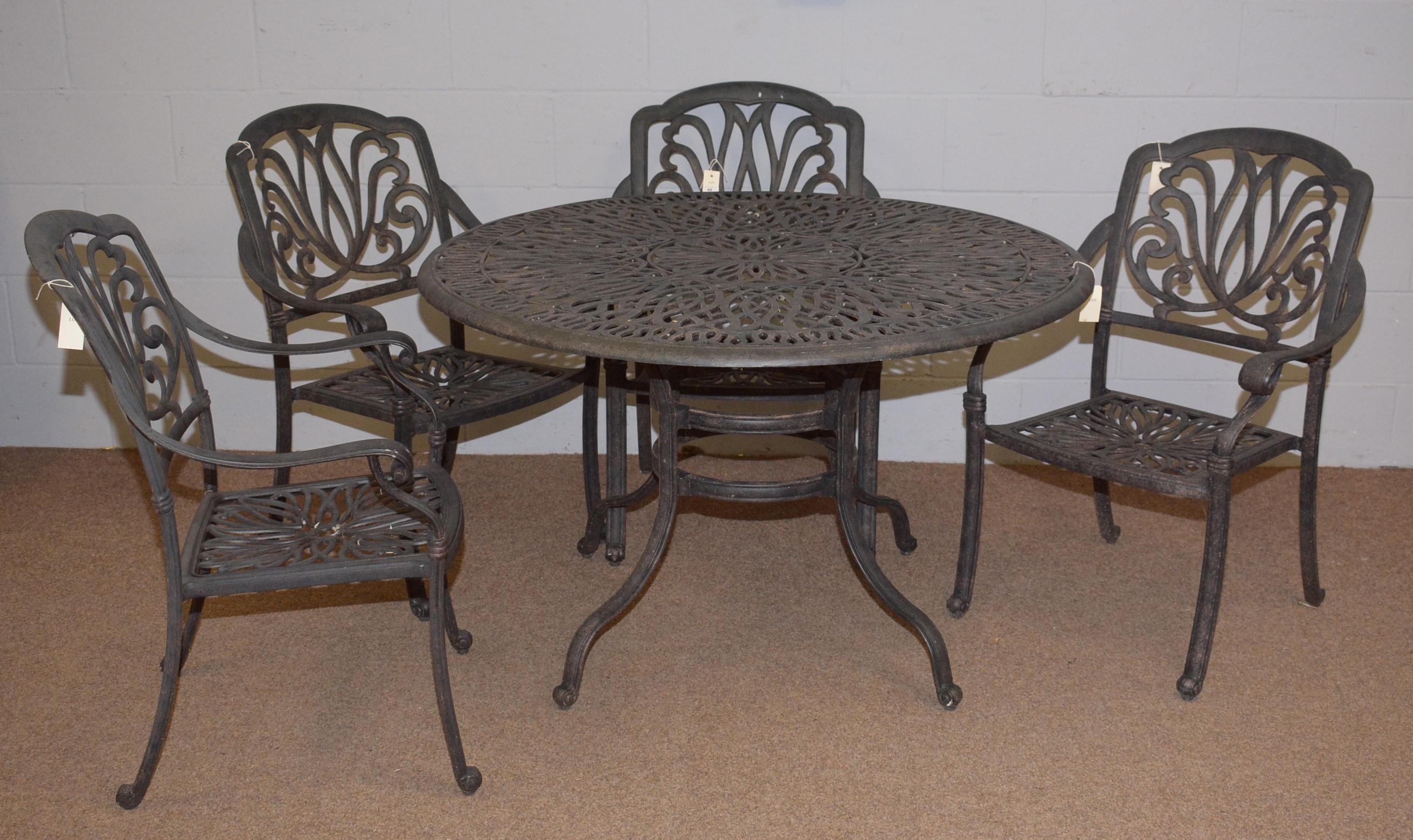 Lot 65 A cast metal garden table and chairs.