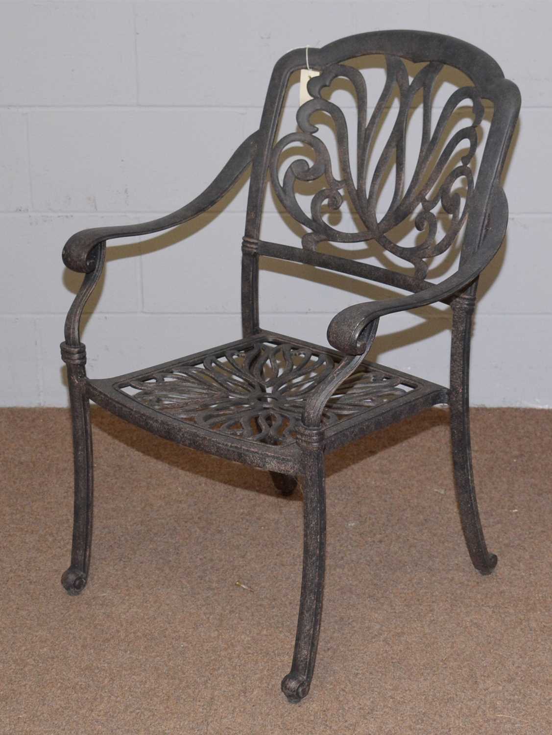 Lot 65 A cast metal garden table and chairs.