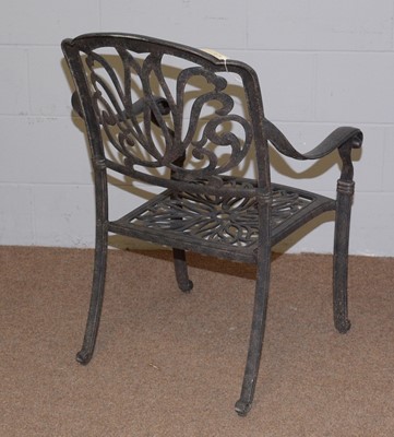 Lot 65 - A cast metal garden table and chairs.