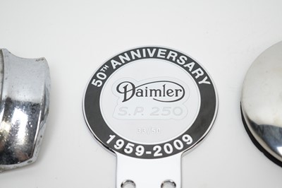 Lot 820 - A selection of Daimler cast metal car badges.