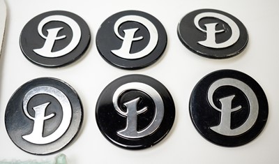 Lot 808 - A selection of Daimler car badges.
