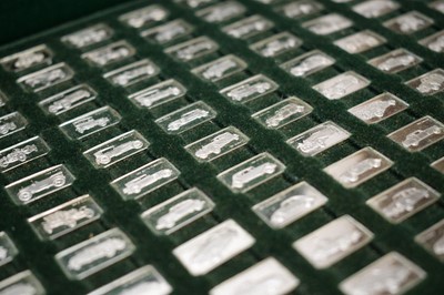 Lot 809 - A collection of miniature silver ingots depicting vintage cars.