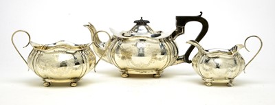 Lot 549 - An Edwardian silver three piece tea service, by Joseph Gloster Ltd