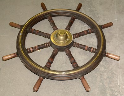 Lot 984 - An early 20th Century brass-mounted turned wood ship's wheel.