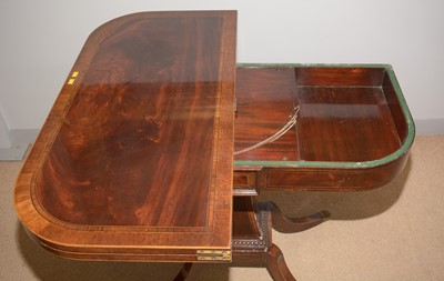 Lot 2 - A late Regency figured mahogany foldover games table