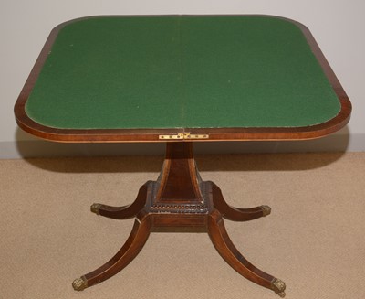 Lot 75 - A late Regency style figured mahogany foldover games table